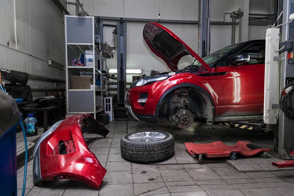 Car with an open hood raised on a lift - Mechanic in Belconnen, ACT