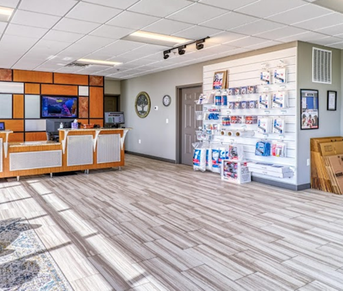 A large room with a wooden floor and a counter in the middle of it.