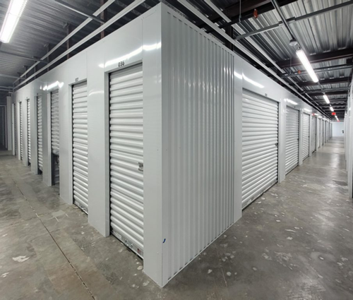 A row of white storage units are lined up in a building.