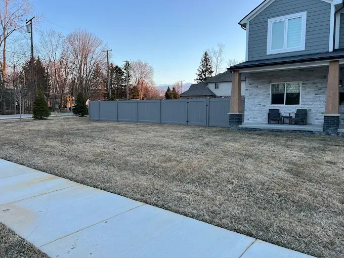A large house with a fence in front of it