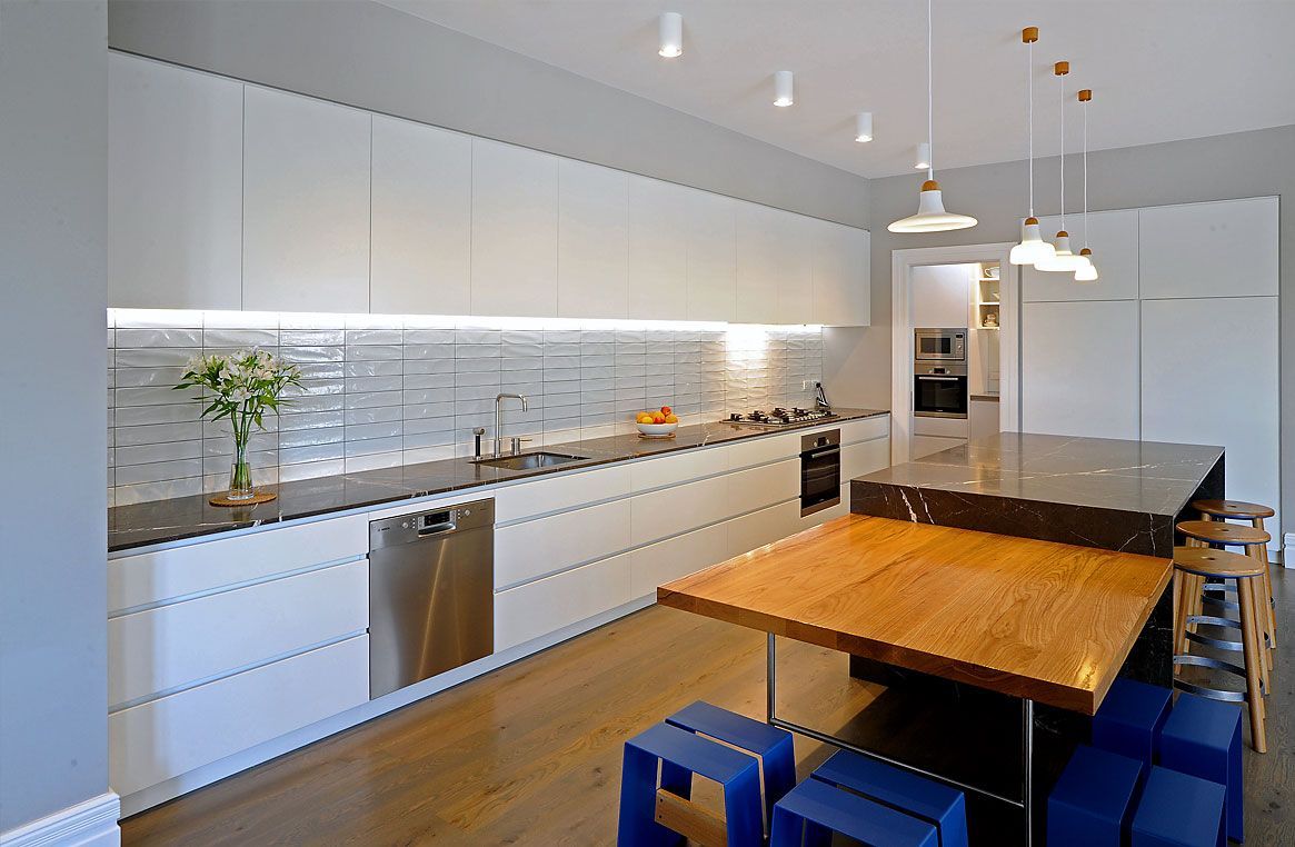 A Kitchen with A Wooden Table and Blue Stools — Canberra Kitchen & Bathroom in Fyshwick, ACT