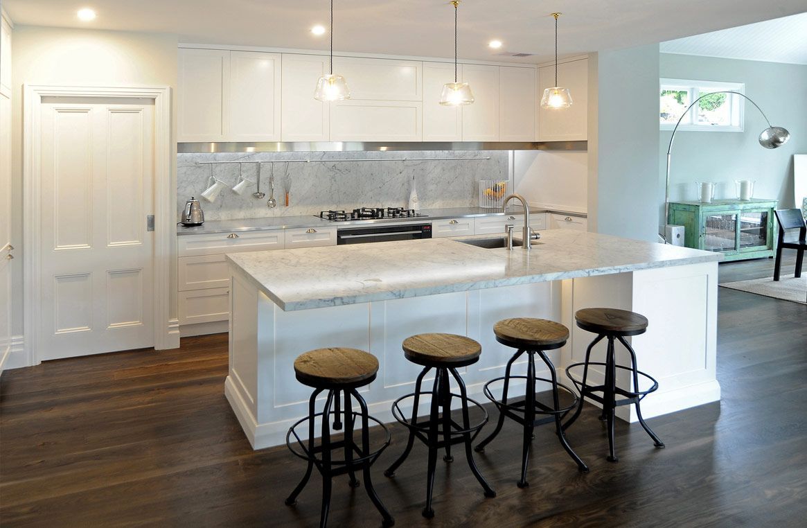 A Kitchen with A Large Island and Four Stools — Canberra Kitchen & Bathroom in Fyshwick, ACT