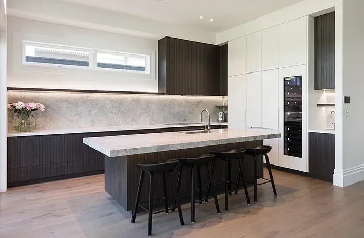 A Kitchen with A Large Island and Stools in It — Canberra Kitchen & Bathroom in Fyshwick, ACT