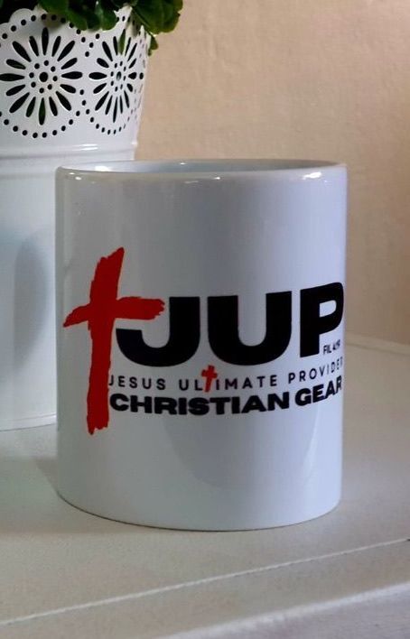 A white mug that says jup on it