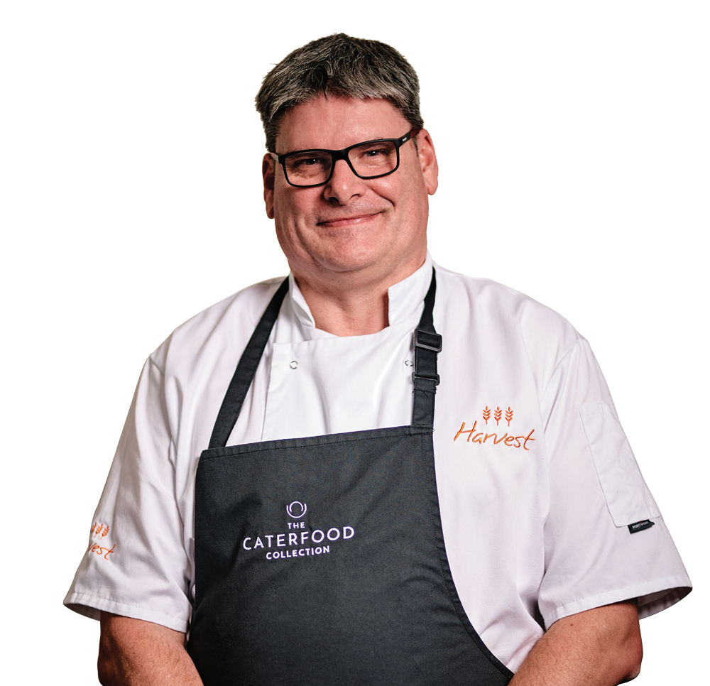 A man wearing an apron that says laterfood on it