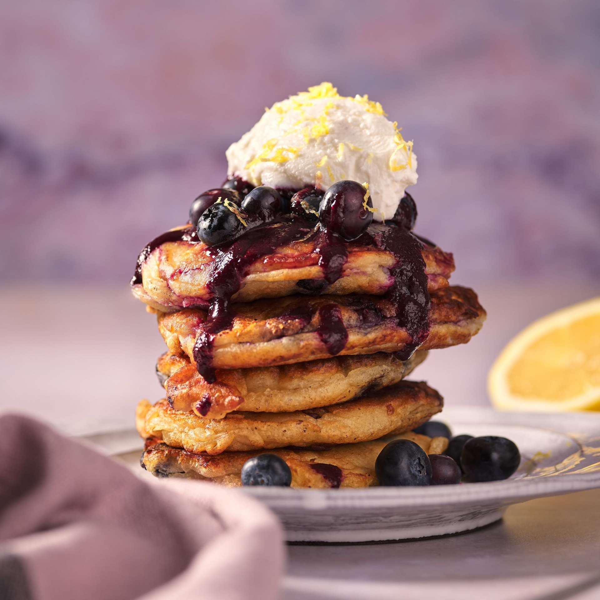 A pan filled with french fries and vegetables next to a bowl of ranch dressing.