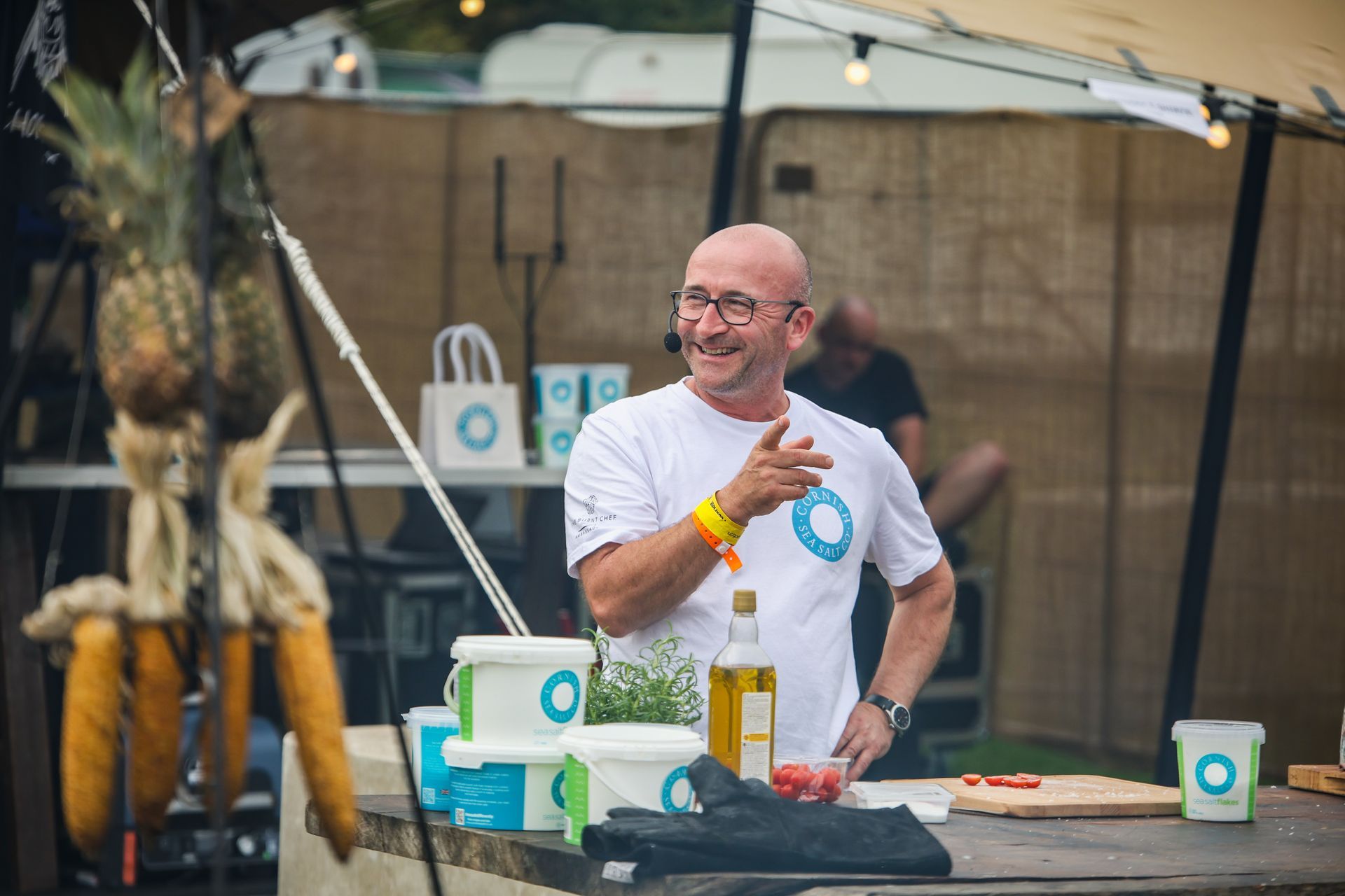 Woman with brown hair smiles, wearing a black dress with gold stars, sitting in a room with books and a sculpture.