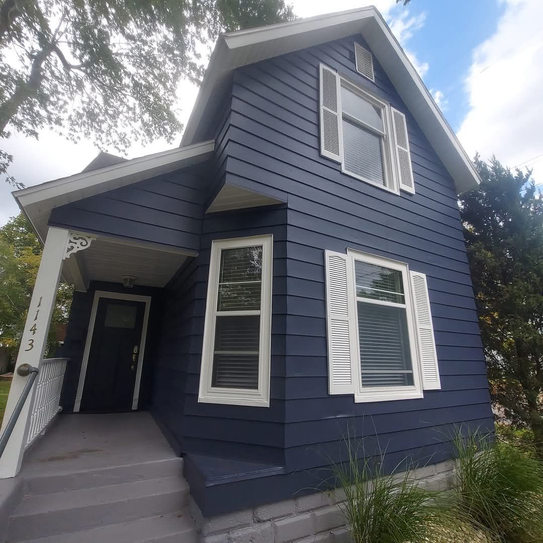 Blue house with white shutters and porch.