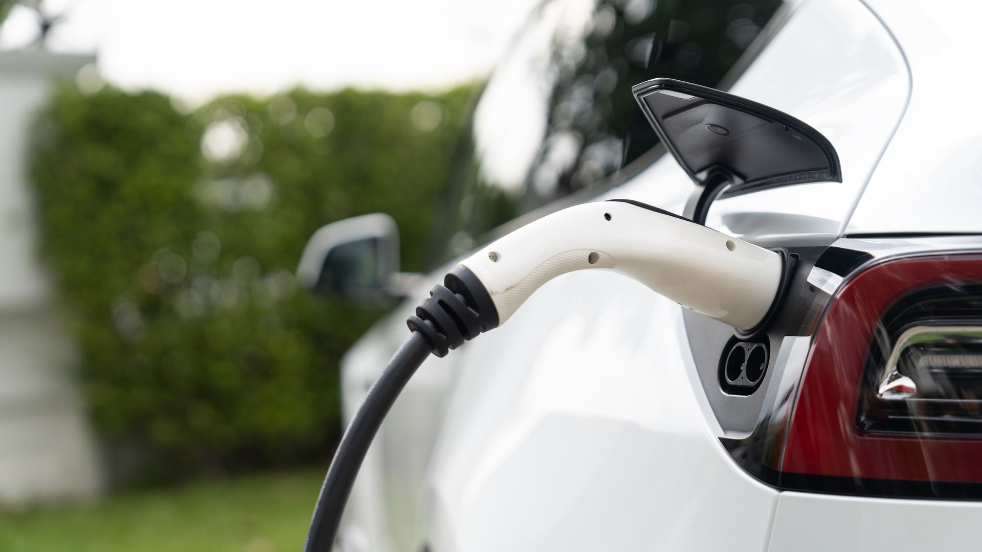 An electric car is being charged at a charging station.