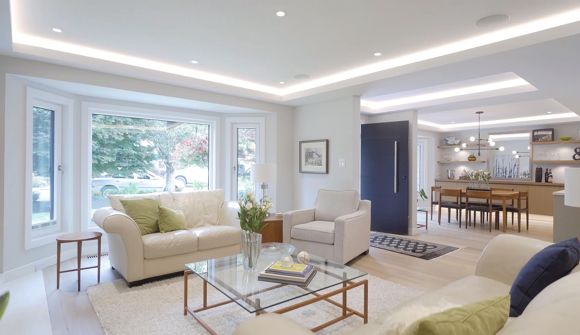 A living room filled with furniture and a glass coffee table.