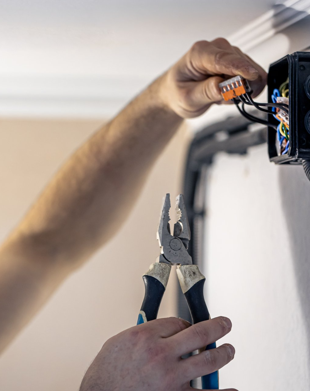 an electrician mounting electric sockets on the wall