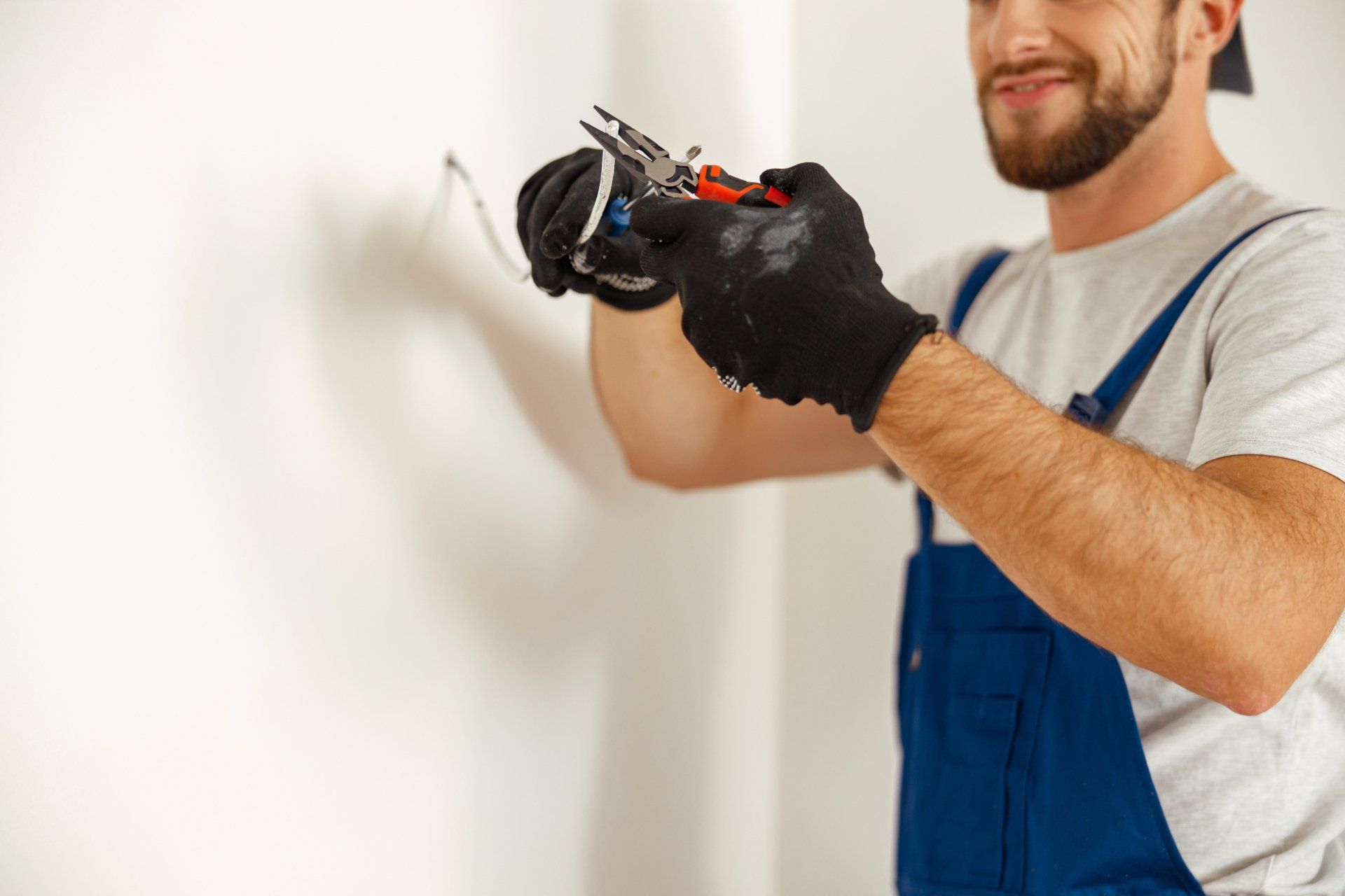 an electrician installing an electrical outlet