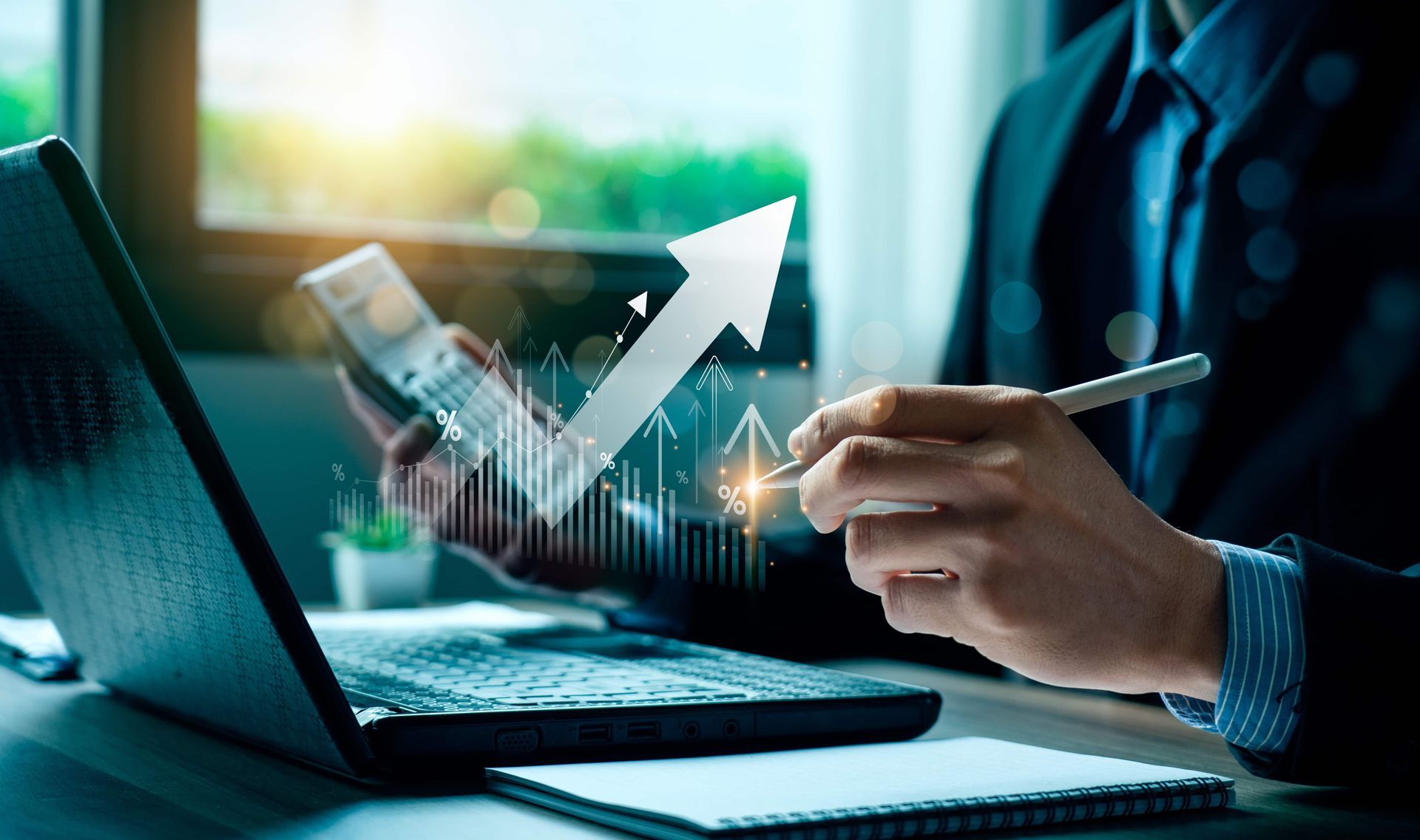 Man in suit analyzing financial data with laptop, graph, and calculator, indicating growth.