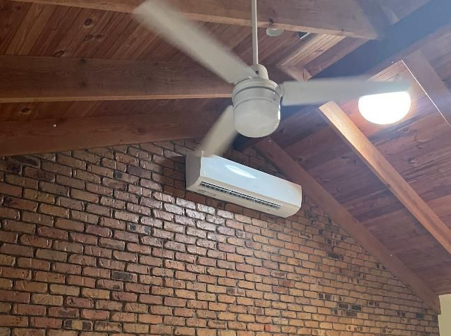 Ceiling Fan and Ac Unit on Brick Wall — Pearson Electrical Solar and Airconditioning in Bundaberg Central, QLD