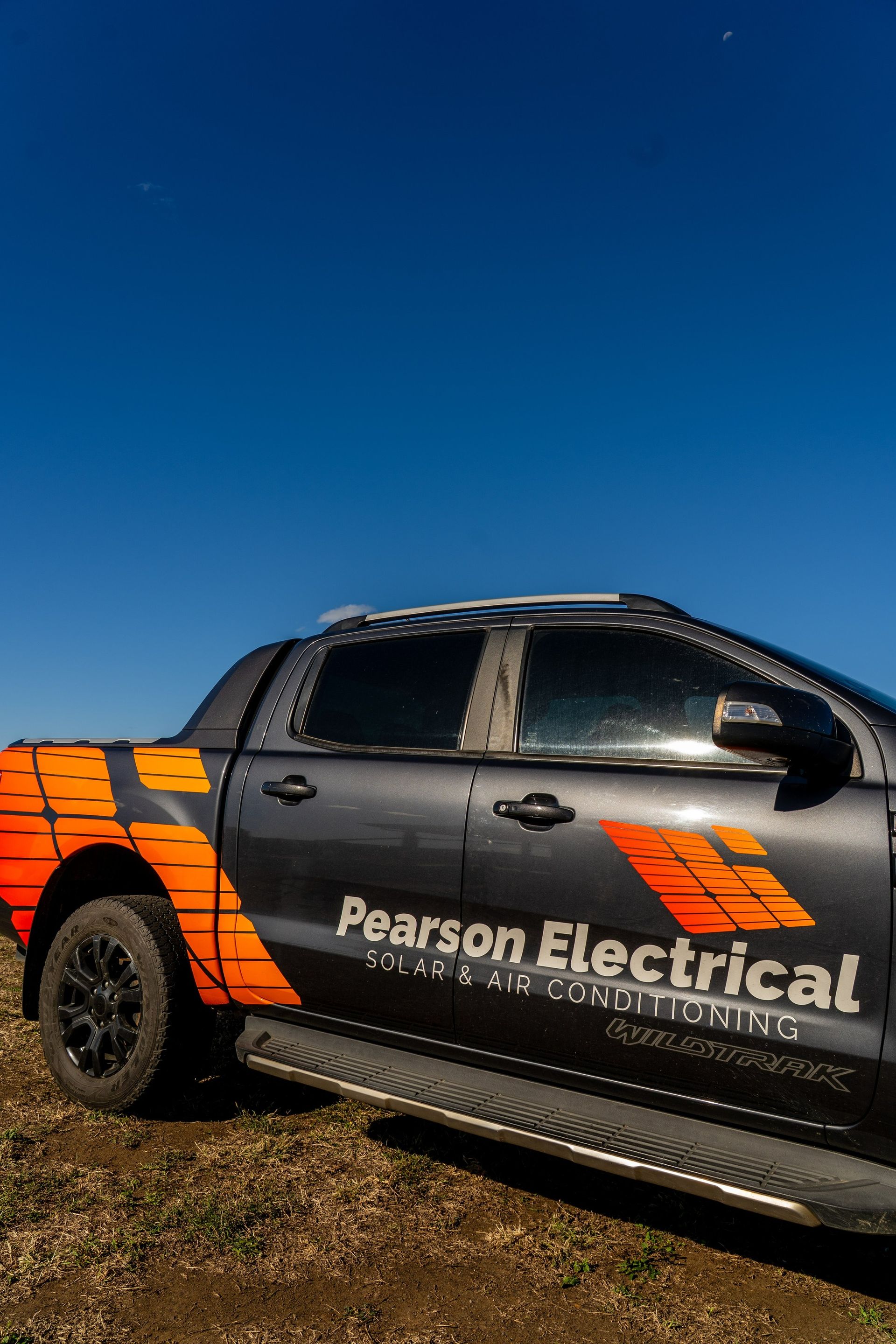 Gray Pearson Electrical Pickup Truck on Dirt — Pearson Electrical Solar and Airconditioning in Bundaberg Central, QLD