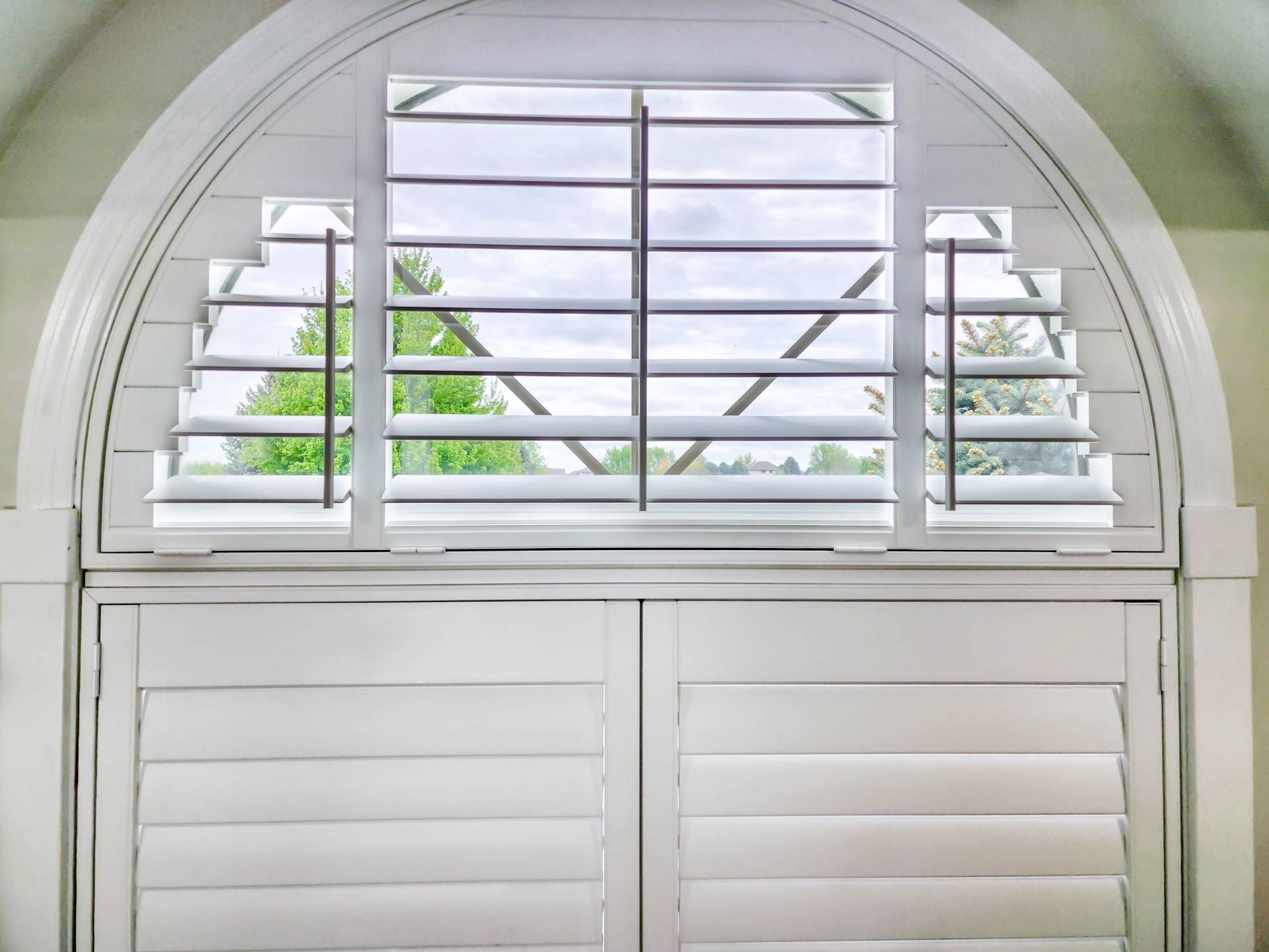 Palm Beach™ Polysatin™ Vinyl Shutters on an arched window at Captivating Windows near Norfolk, NE 