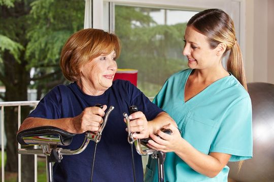 nurse taking care of an aged woman