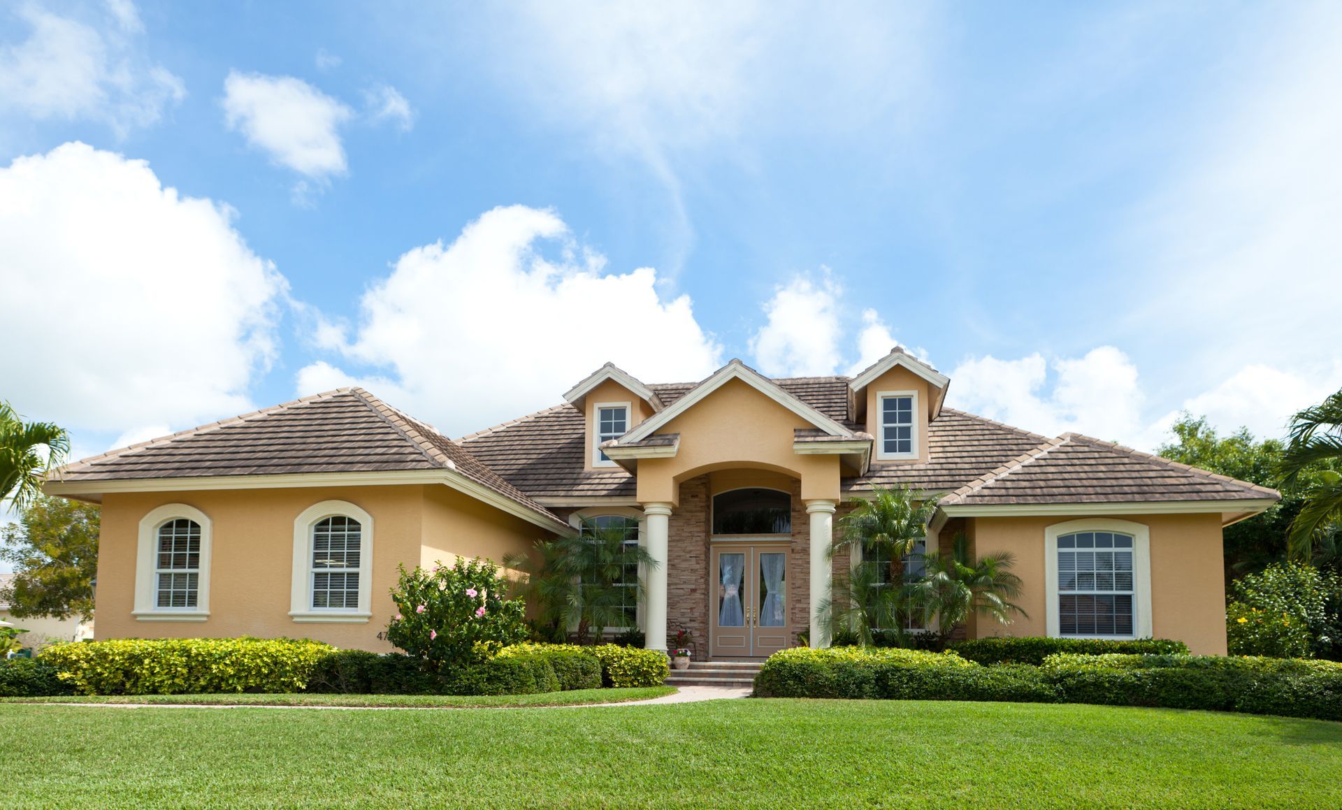 A large house with a lush green lawn in front of it