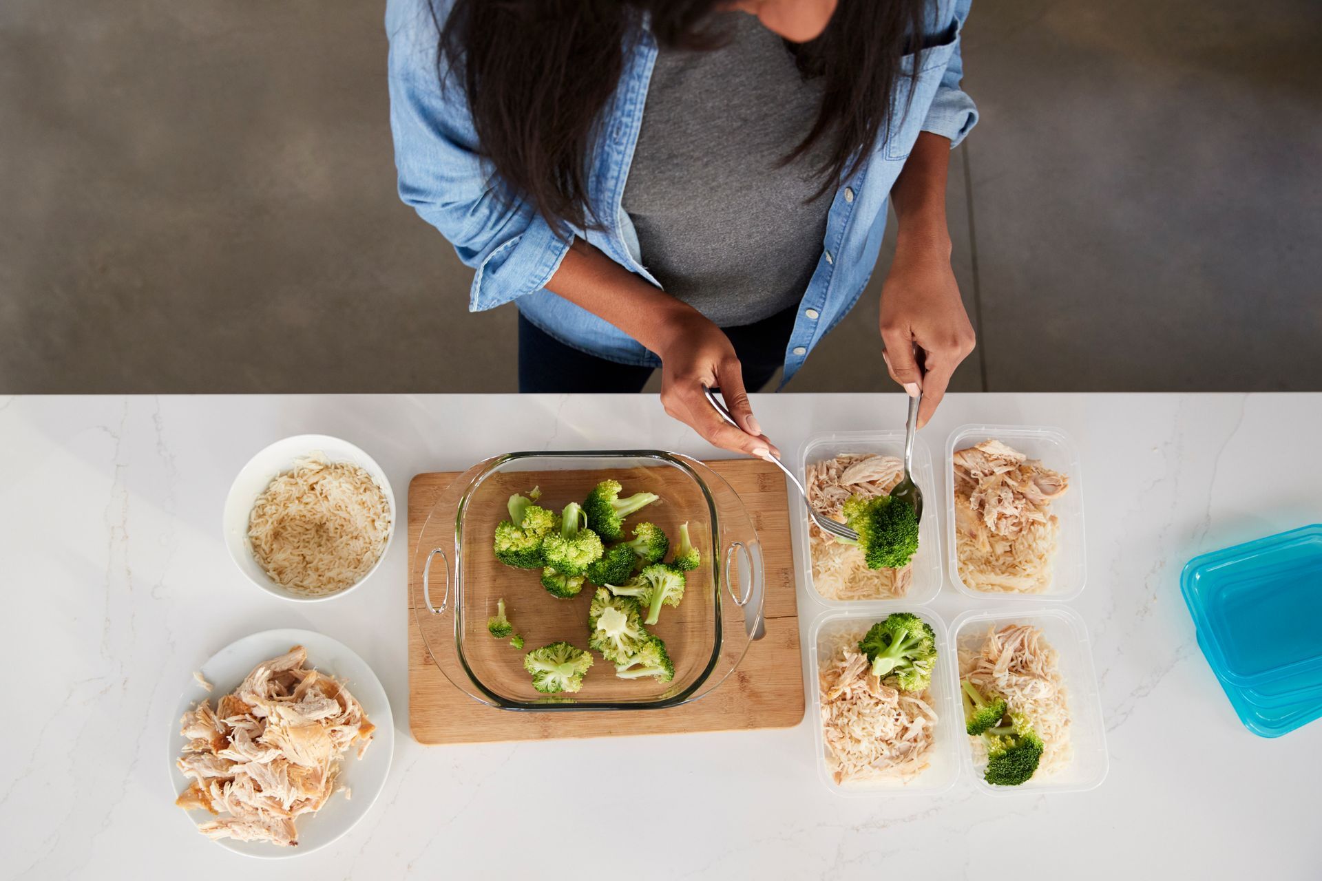 Person preparing meal prep containers