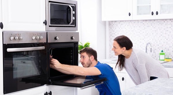 A professional doing an appliance repair in Clementon, NJ