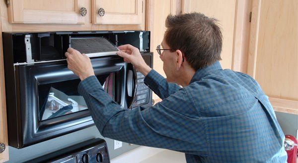 Handyman Repairing The Fan Over a Microwave — Voorhees, NJ — Appliance Werks