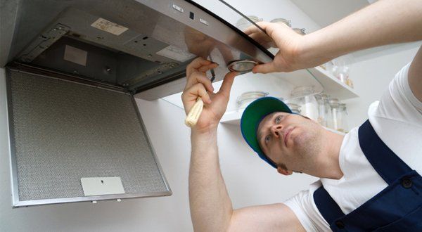 Appliance Maintenance — Foreman Fixing Exhaust Hood in The Kitchen in Voorhees, NJ