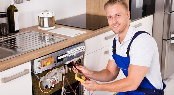 Young Male Technician Checking Dishwasher — Voorhees, NJ — Appliance Werks