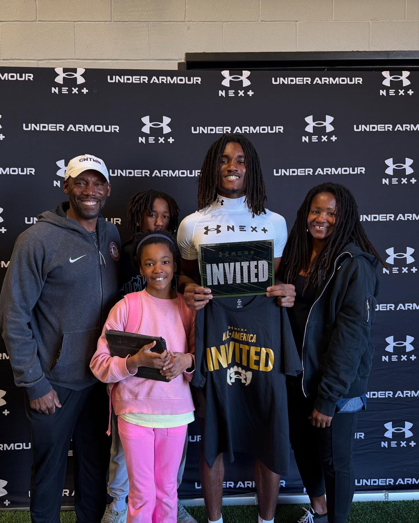 Family poses with a young person holding 