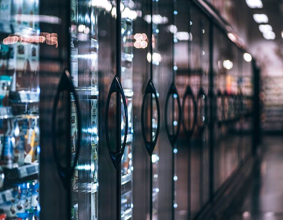 A row of refrigerators in a grocery store.
