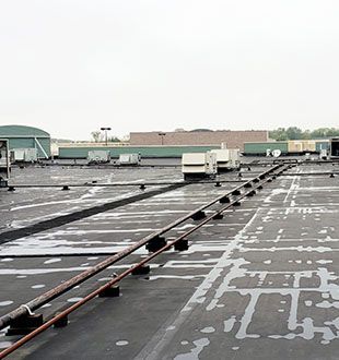 The roof of a building with a lot of pipes on it.