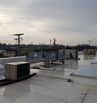 The roof of a building with a lot of air conditioning equipment on it.