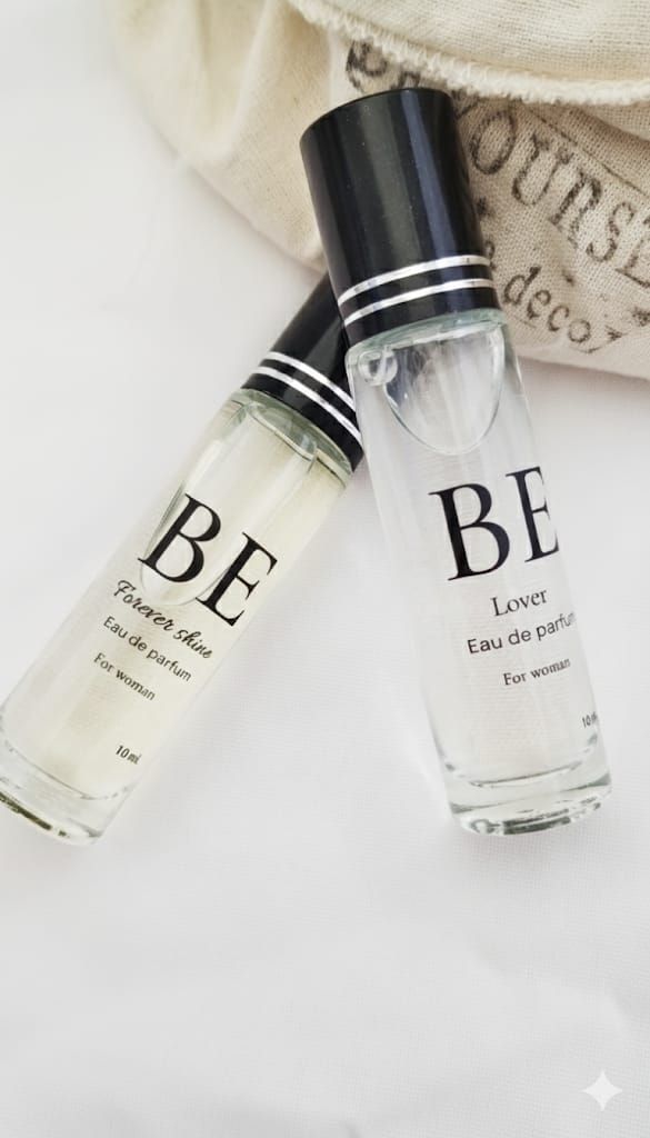 Dos frascos de perfume de vidrio con tapa negra y etiqueta blanca con la inscripción