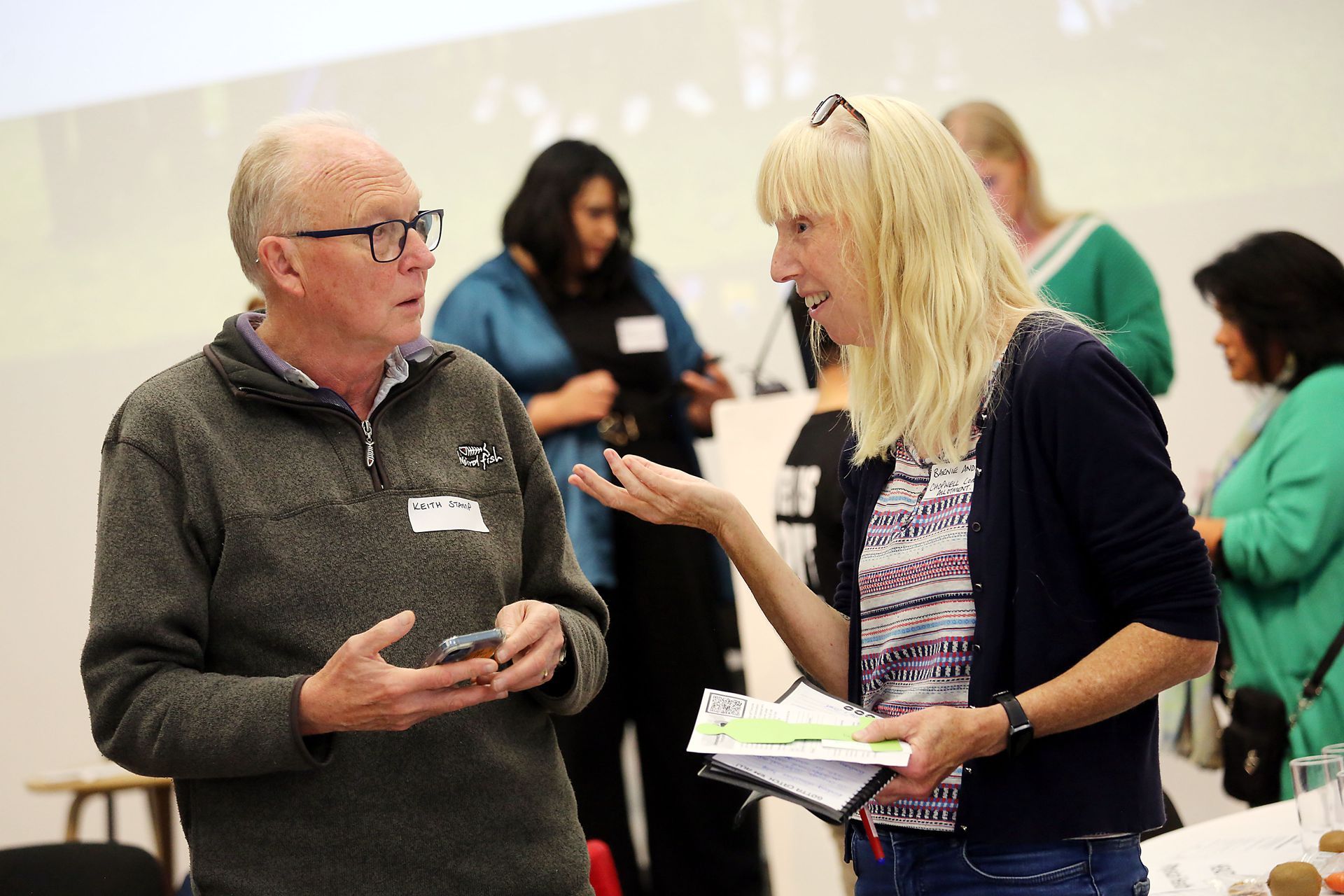 A man and a woman are talking to each other in a room.