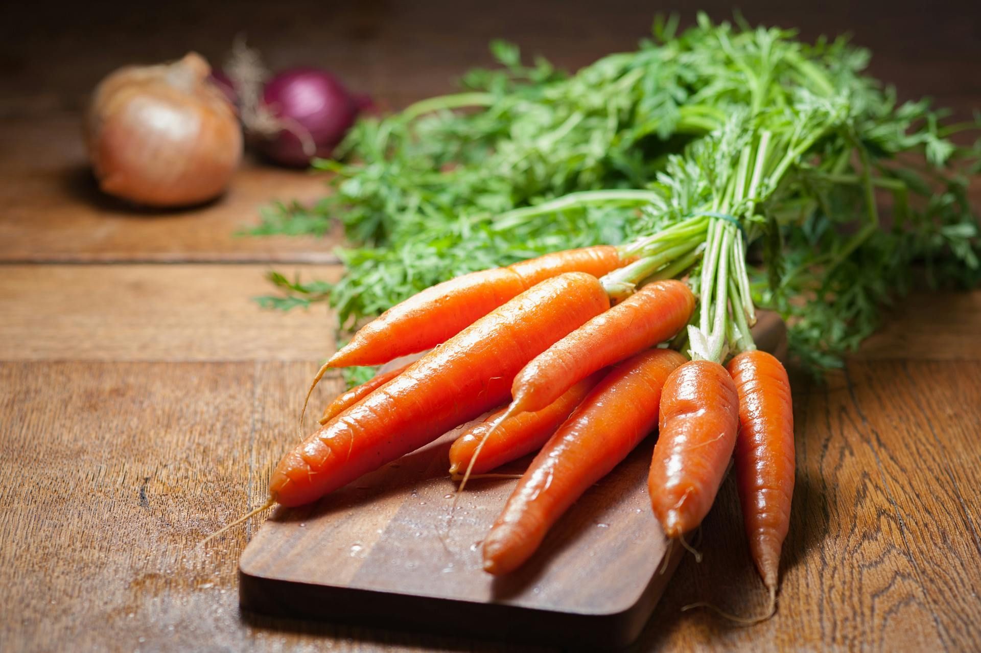 A variety of vegetables including tomatoes , cucumbers , cabbage , onions and peppers