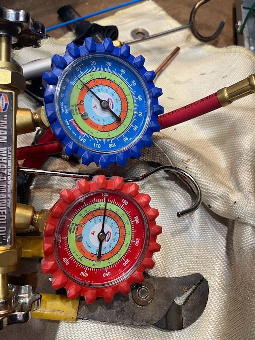 a pair of gauges are sitting on a table next to a pair of pliers .