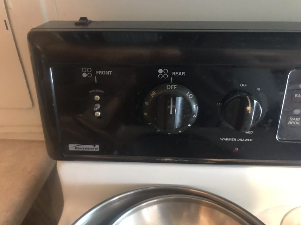 a close up of a stove with the front and rear knobs