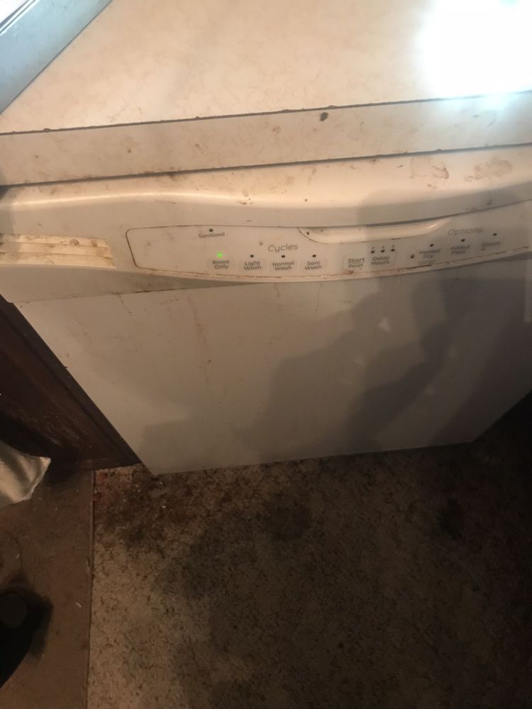 a white dishwasher is sitting on a counter in a kitchen .