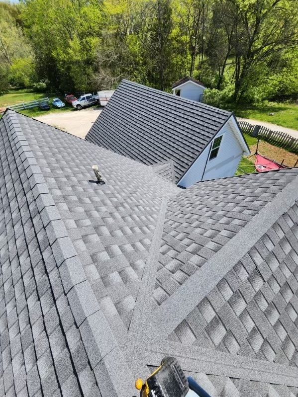 A roof of a house with metal shingles on it