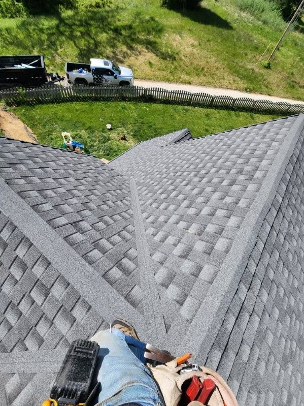 A person is standing on top of a roof
