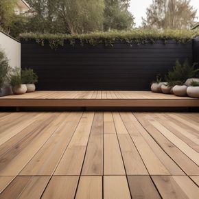 a wooden deck with a black fence in the background