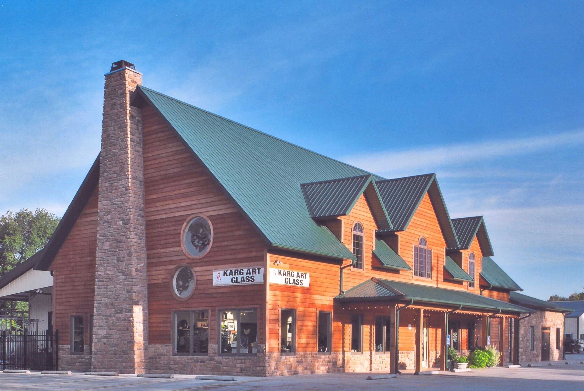 A large building with a green roof and a blue sky in the background