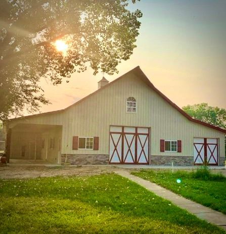 A large red barn with a blue sky in the background