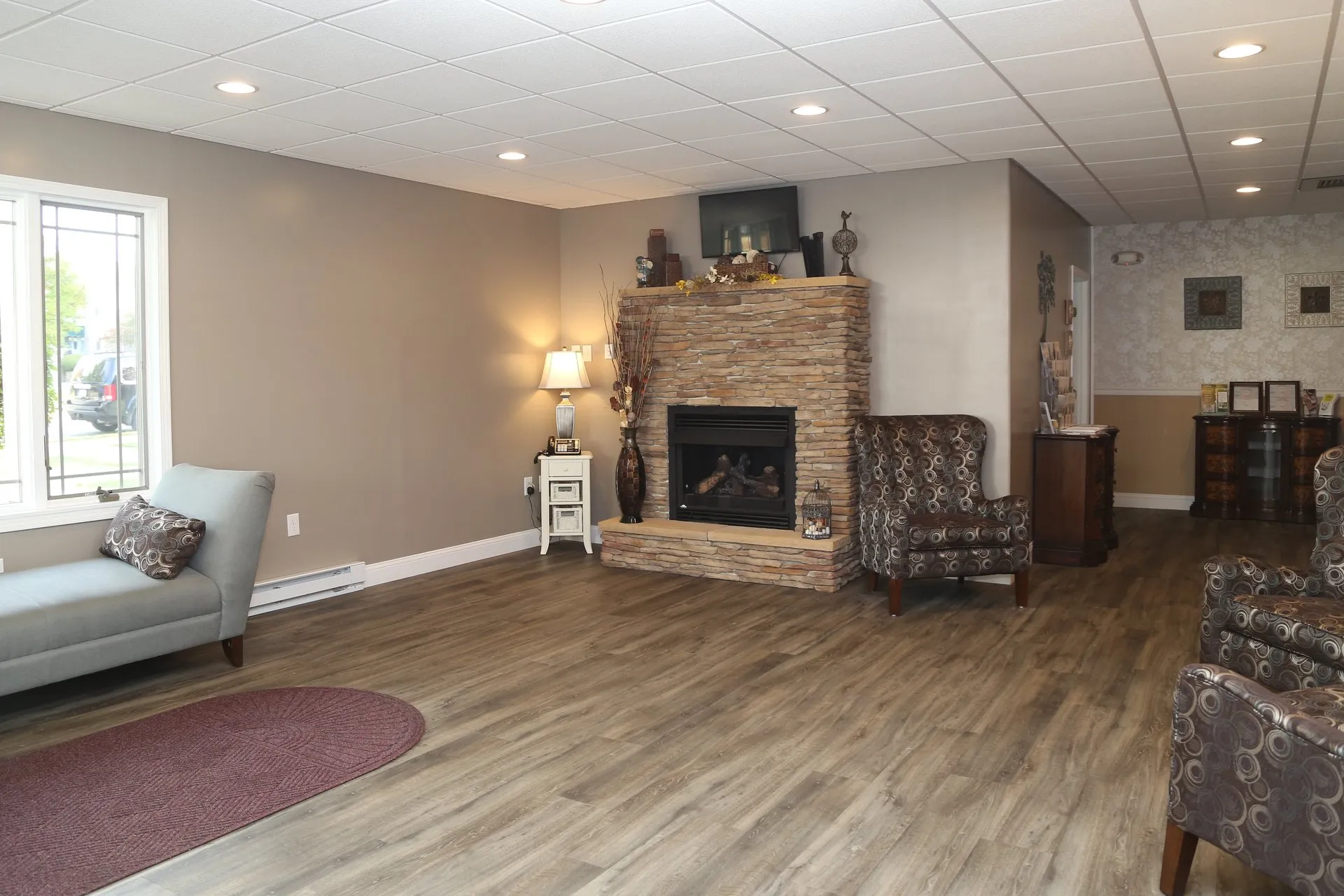 funeral home facilities room with fireplace and lit lamp at the corner