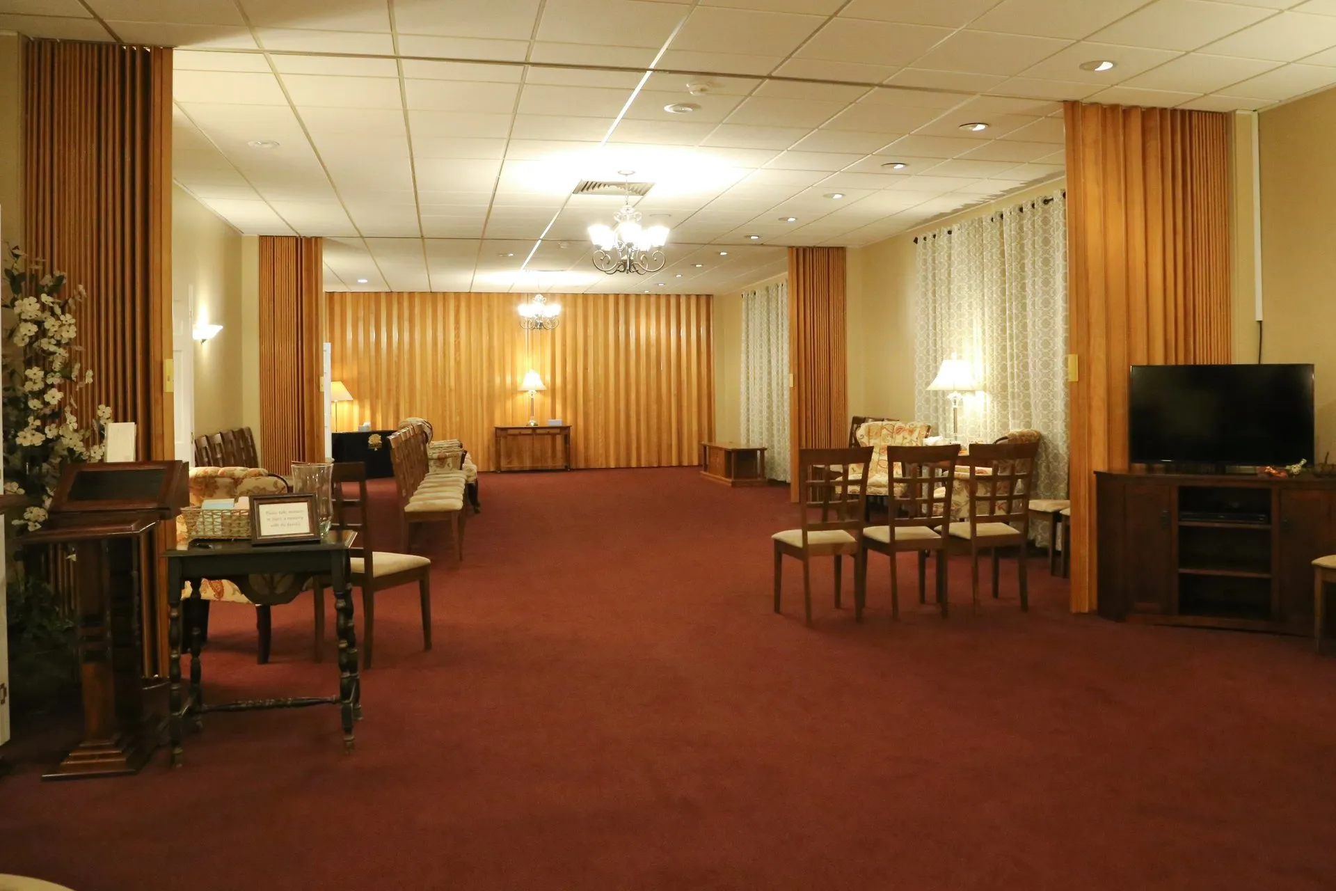 funeral home facilities room with wooden chairs