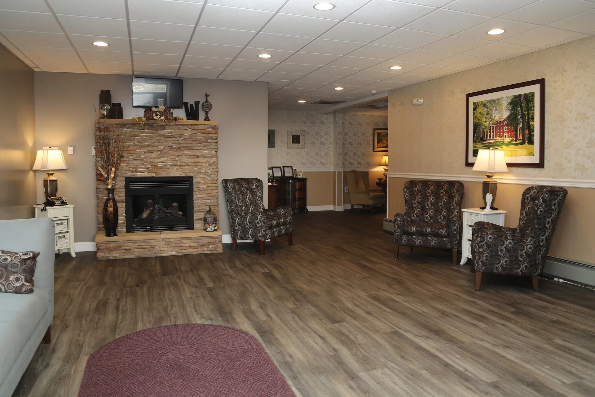 funeral home facilities room with fireplace and three large chairs