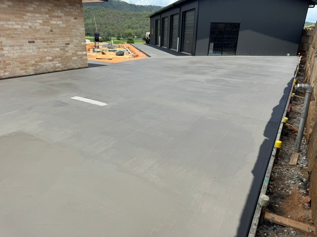 Newly Poured Concrete Driveway With a Gray Finish — Asphalt & Concreting Services & Solutions in Logan Village, QLD

