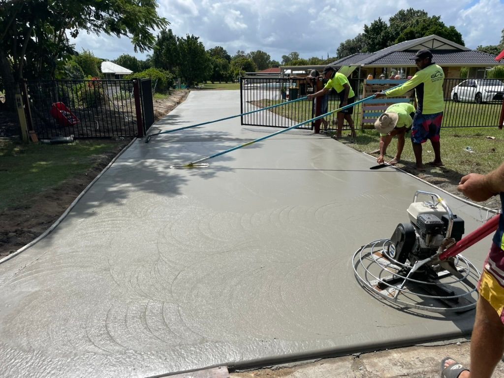 Construction Workers Finishing a Concrete Driveway — Asphalt & Concreting Services & Solutions on the Gold Coast, QLD
