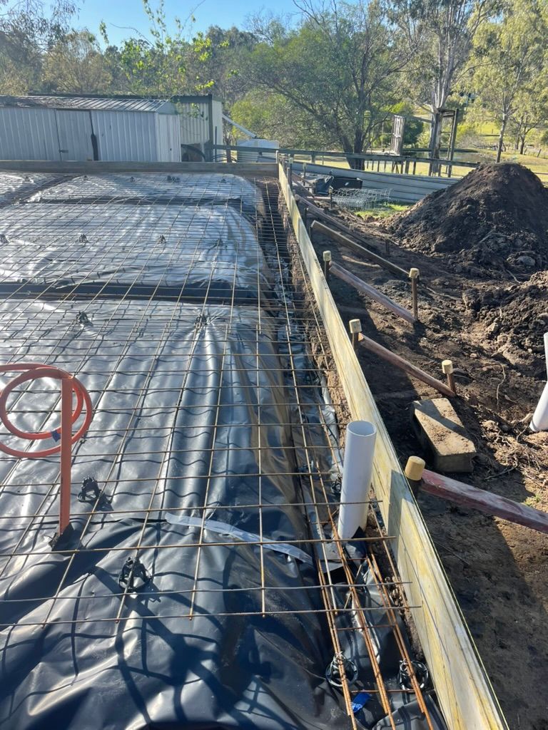 Construction Site With Rebar Grid Over Black Sheeting — Asphalt & Concreting Services & Solutions in Logan Village, QLD