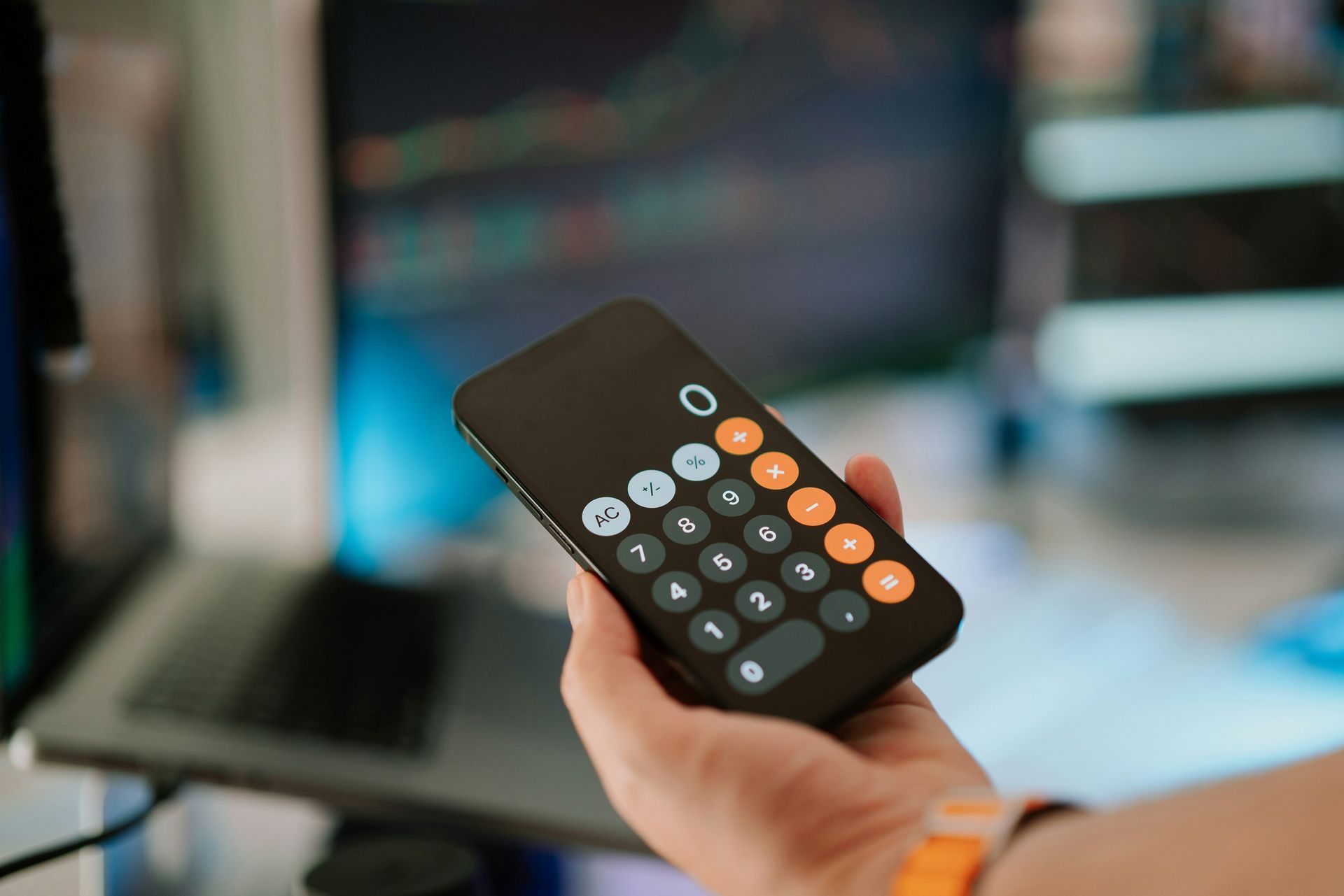 A person is holding a remote control in their hand.