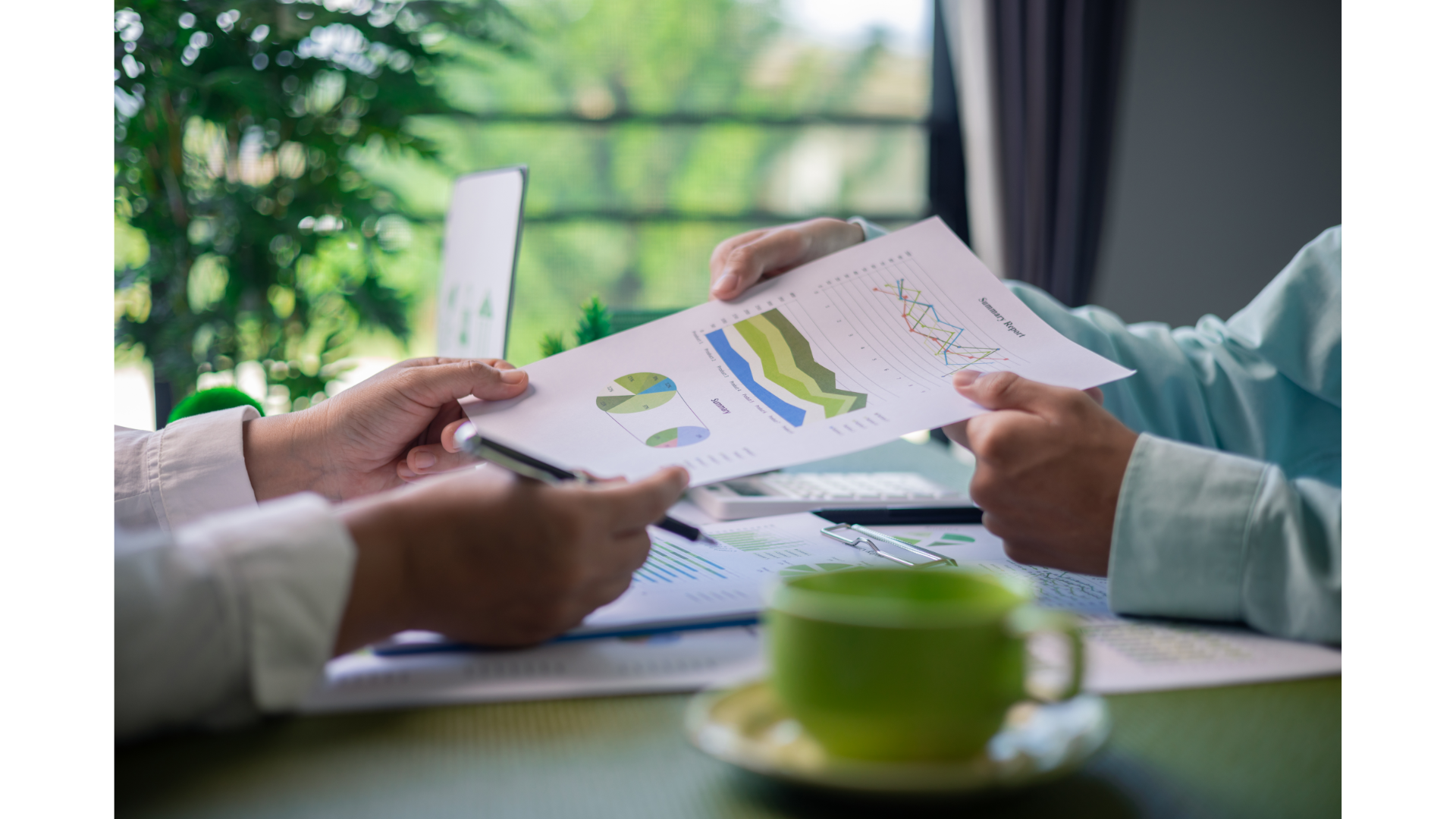 Two people are sitting at a table looking at a piece of paper.